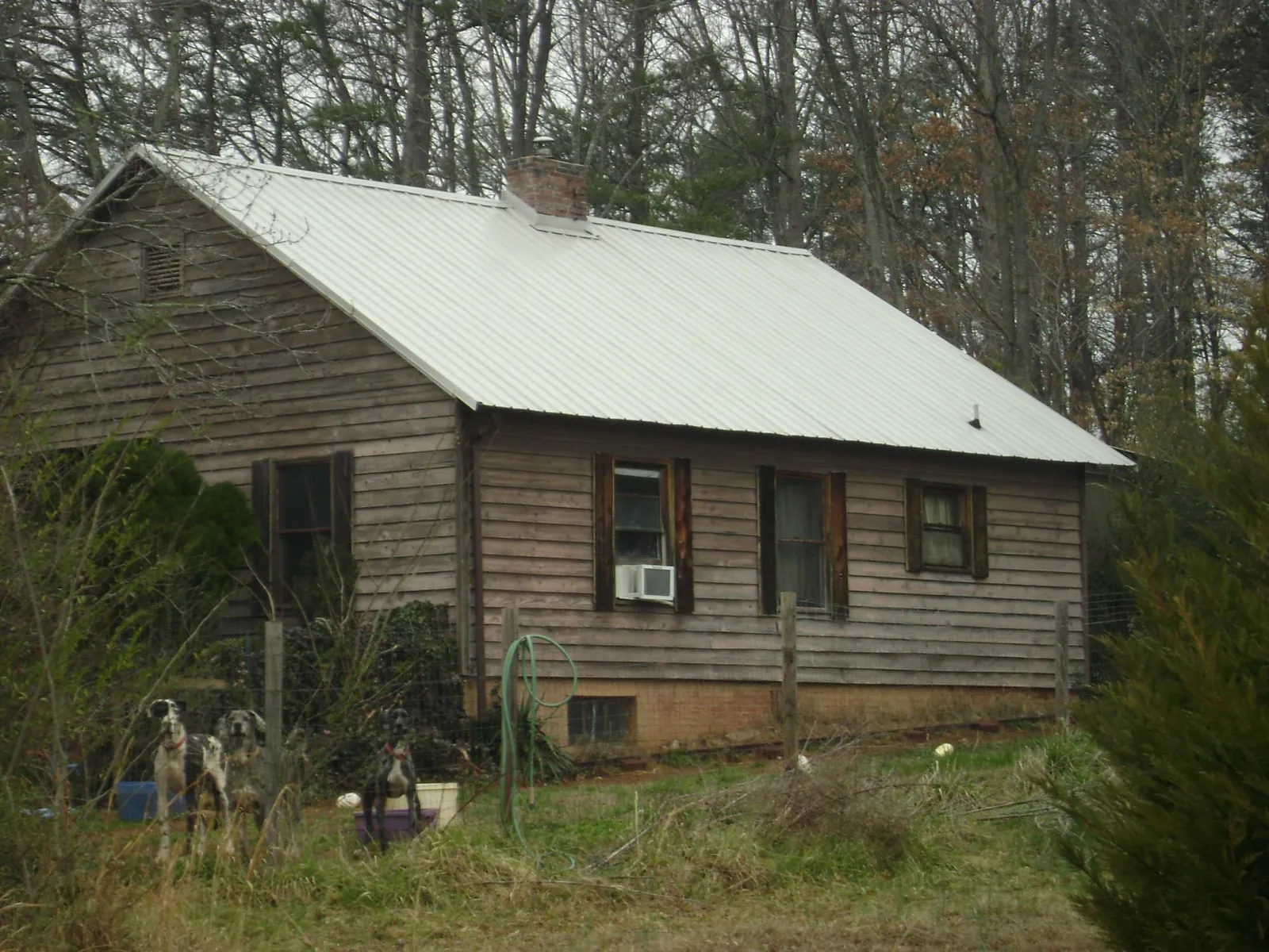 White metal roof on an old wood sided farmhouse, from a Metal Roof Installation job in Cranbury